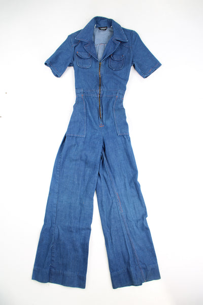 Vintage 1970's style wide leg, zip up denim jumpsuit with dagger collar and chest pockets. Features elasticated waistband at the back.