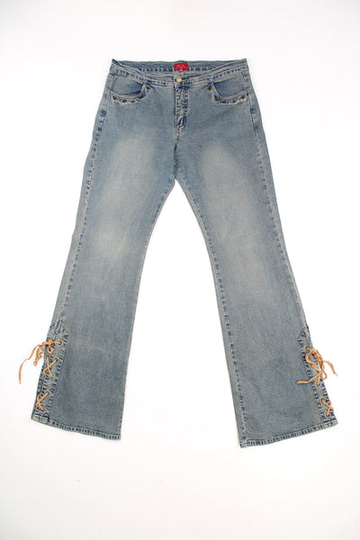 Per Una Y2K Vintage Flared Jeans in a faded blue colourway, mid rise, side pockets and lace details going down the sides of each leg.