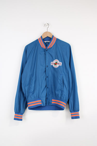 Vintage 90's Florida Gators thin varsity bomber Jacket, from Chalk Line by. Features embroidered Gators logo on the chest and closes with snap buttons down the front.  Size in Label: Mens M