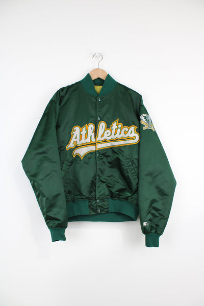 Oakland Athletics, Starter Varsity Jacket in a green, white and yellow team colourway, satin with a quilted lining, button up, and has spell out logo across the chest along with team logo on the left sleeve.