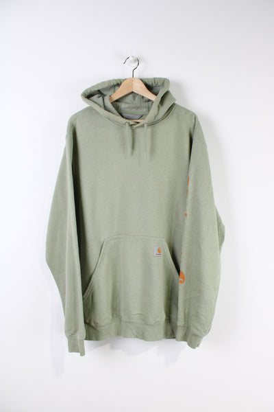 Carhartt green hoodie with branded logo on the pocket and Carhartt spell-out on the sleeve.