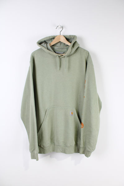 Carhartt green hoodie with branded logo on the pocket and Carhartt spell-out on the sleeve.