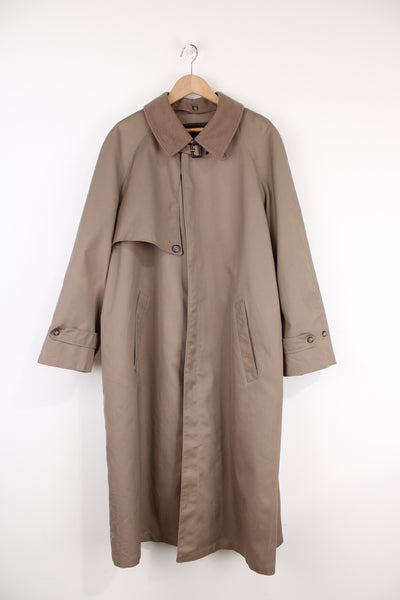 Chrisitan Dior Monsieur button up trench coat, in a light brown. Features a wool liner jacket and collar
