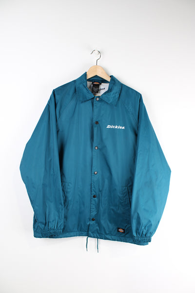 Vintage Dickies blue coach button up jacket with pockets and logo printed on the chest.