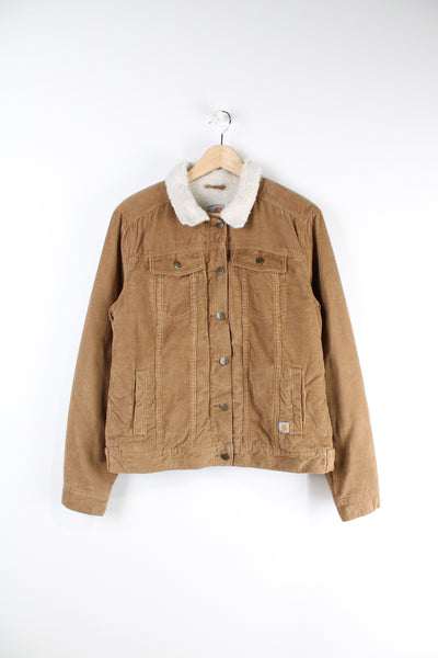 Carhartt tanned button up corduroy jacket, has a sherpa lining with a white collar, multiple pockets and branded logo at the bottom. 