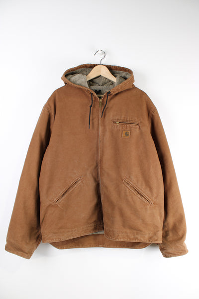Vintage Carhartt brown active jacket with sherpa lining, multiple pockets, hood and Carhartt logo on the chest.