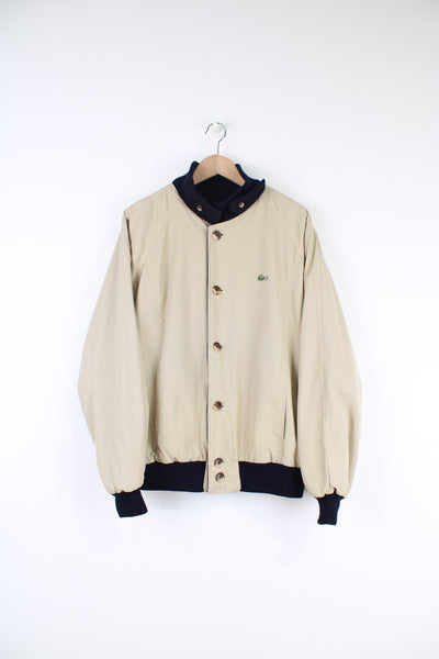 Vintage 90's Lacoste reversible button up bomber jacket, features signature embroidered crocodile on the chest. Tan cotton on one side and navy wool on the reverse