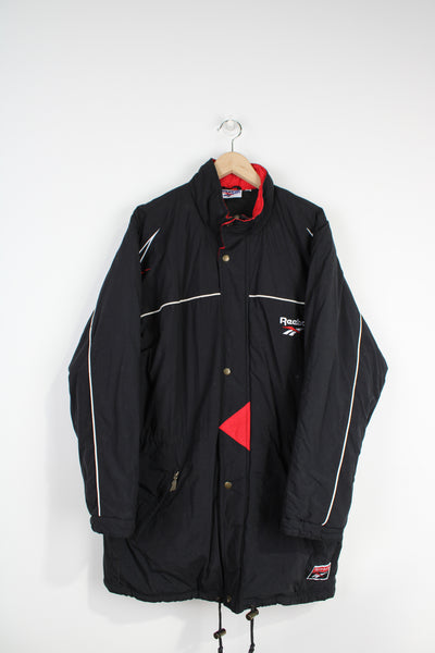 Reebok black zip through sports coat, with embroidered logo on the chest and back of the coat 