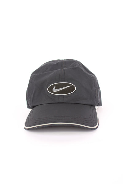 Nike all black nylon golfers cap, features raised swoosh logo on the front and adjustable strap