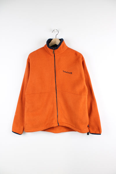 Timberland orange zip through fleece features embroidered logo on the front
