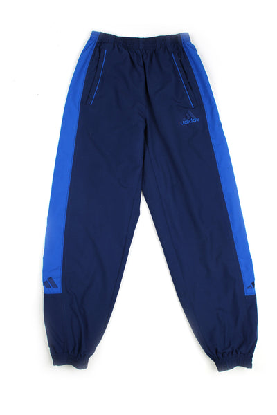 Vintage 90's Adidas blue tracksuit bottoms with embroidered logo, blue stripe down the side, has a elasticated waist and cuffed at the bottom. 