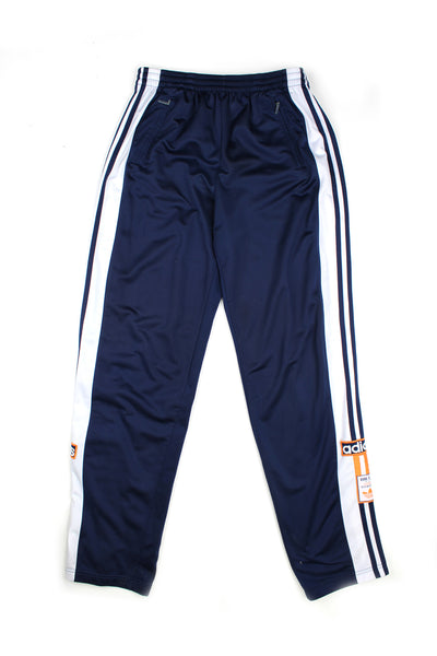 Vintage 90's Adidas popper tracksuit bottoms with white stripes and embroidered logo alongside the buttons, also has a elasticated waist.
