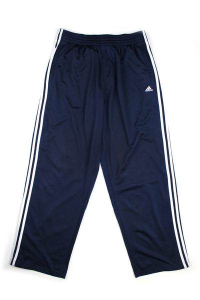 Vintage 00's Adidas blue popper tracksuit bottoms with white stripes down the side along with the buttons, embroidered logo, and has a elasticated waist.