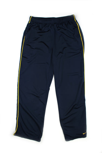 Vintage 00's Nike blue tracksuit bottoms with yellow stripes down the side, embroidered swoosh logo on the bottom left leg, and has a elasticated waist.