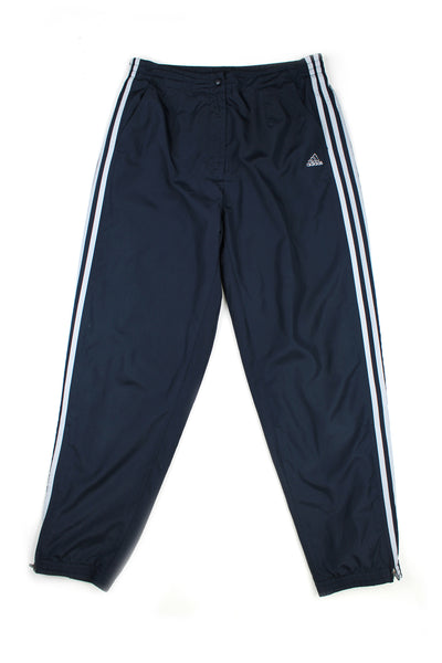 Vintage 00's Adidas blue tracksuit bottoms white stripes down the side, embroidered logo, has a elasticated waist and cuffed at the bottom.