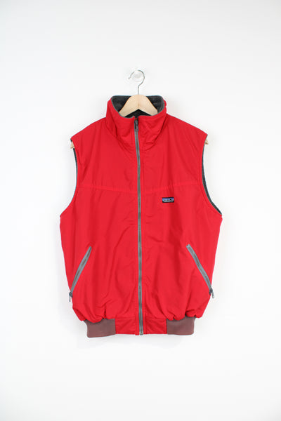 Vintage 1990's Patagonia red nylon gilet with grey fleece lining with embroidered logo on chest and zip up pockets