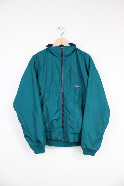 Vintage 90's teal blue Patagonia zip through jacket with fleece lining and embroidered logo on the chest