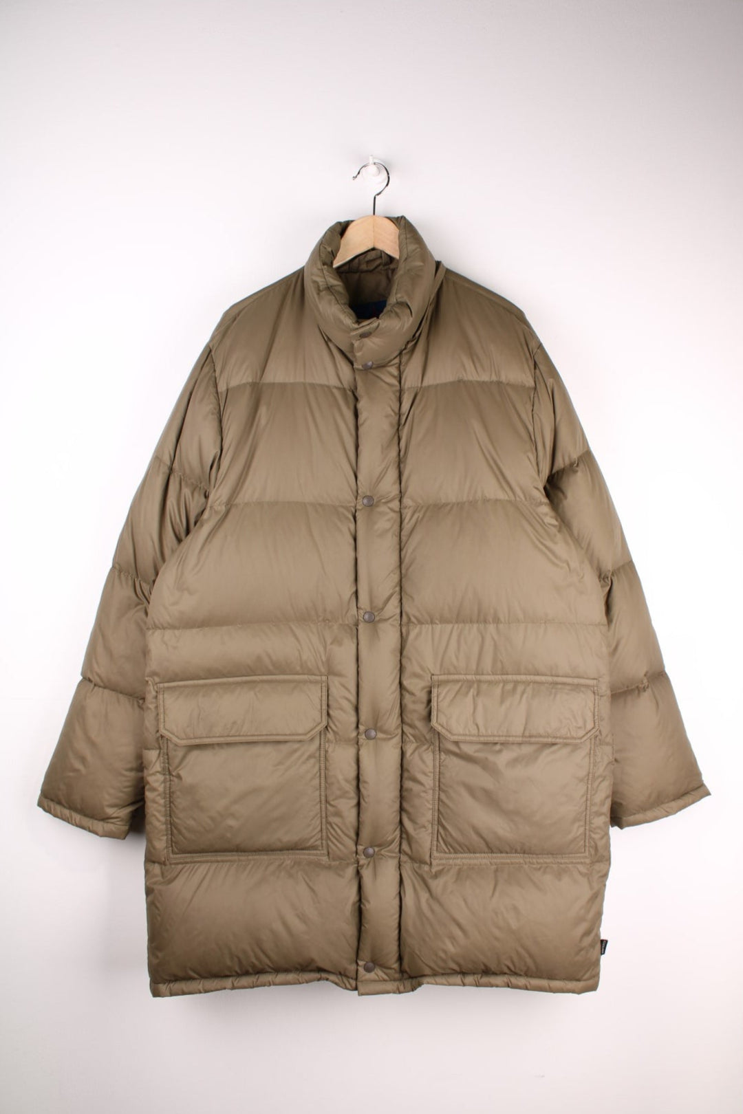 Moncler Jacket in a green colourway. The jacket is filled with duvet down feathers,  has two front pockets, and is a longline fit. The coat is missing the hood and has some minor wear to the shoulder, as seen in the photos