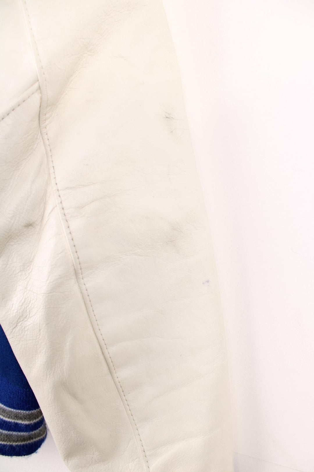 Vintage Delong, Fruita Monument Wildcats varsity jacket in blue with white leather sleeves. Features embroidered letterman patches and large spell out embroidery across the back.  