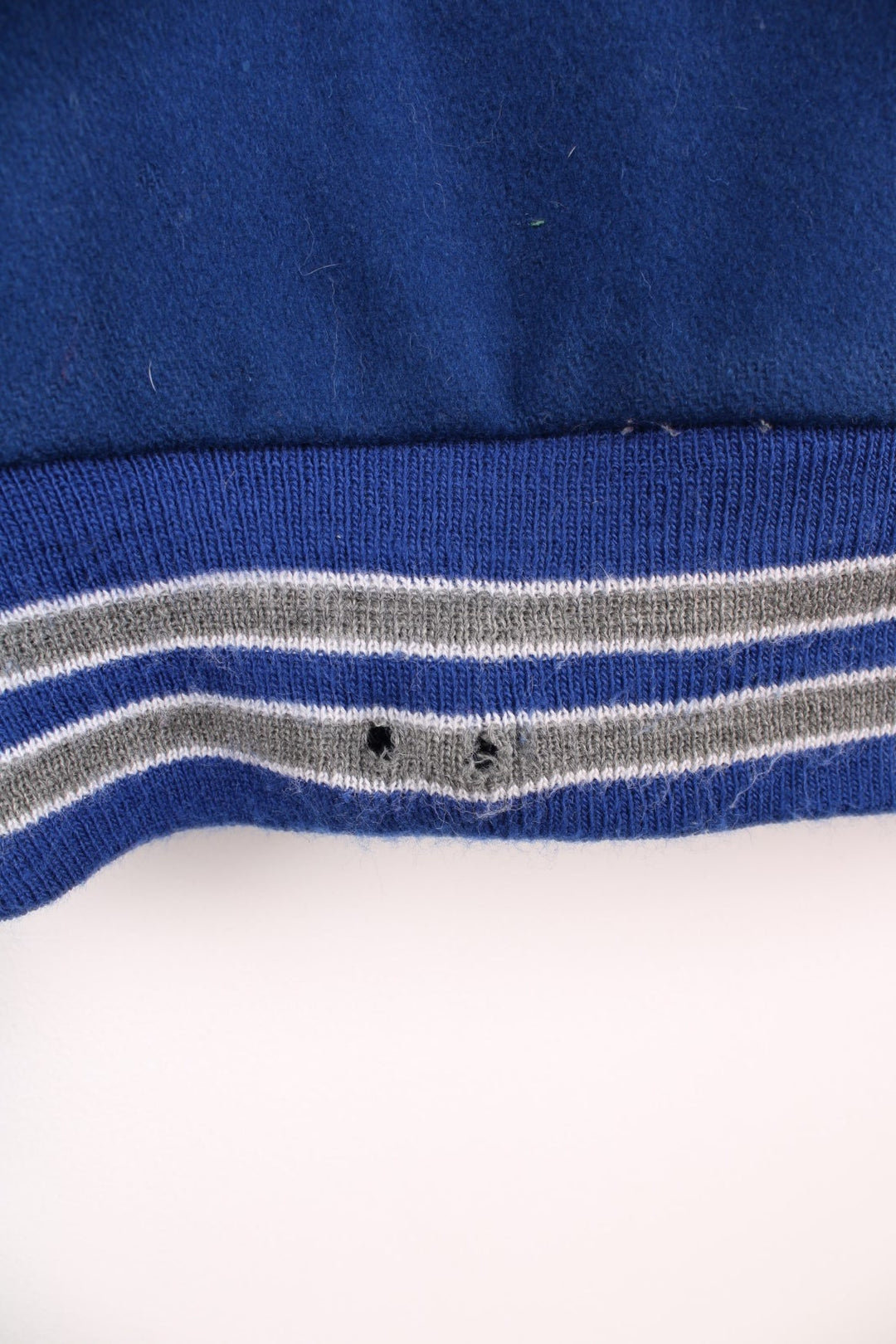 Vintage Delong, Fruita Monument Wildcats varsity jacket in blue with white leather sleeves. Features embroidered letterman patches and large spell out embroidery across the back.  