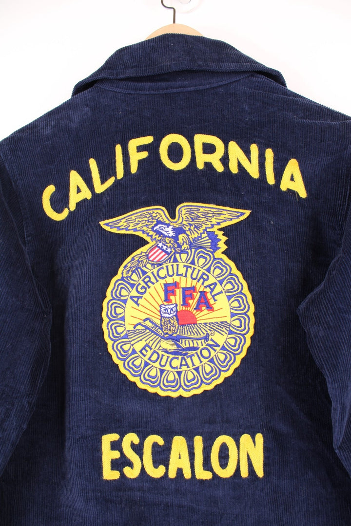 1980s FFA Agricultural Education, Escalon, California navy blue corduroy jacket with FFA crest on front and back, and the name 'Samantha Bavaro' embroidered. With zip closure and two slit side pockets. 