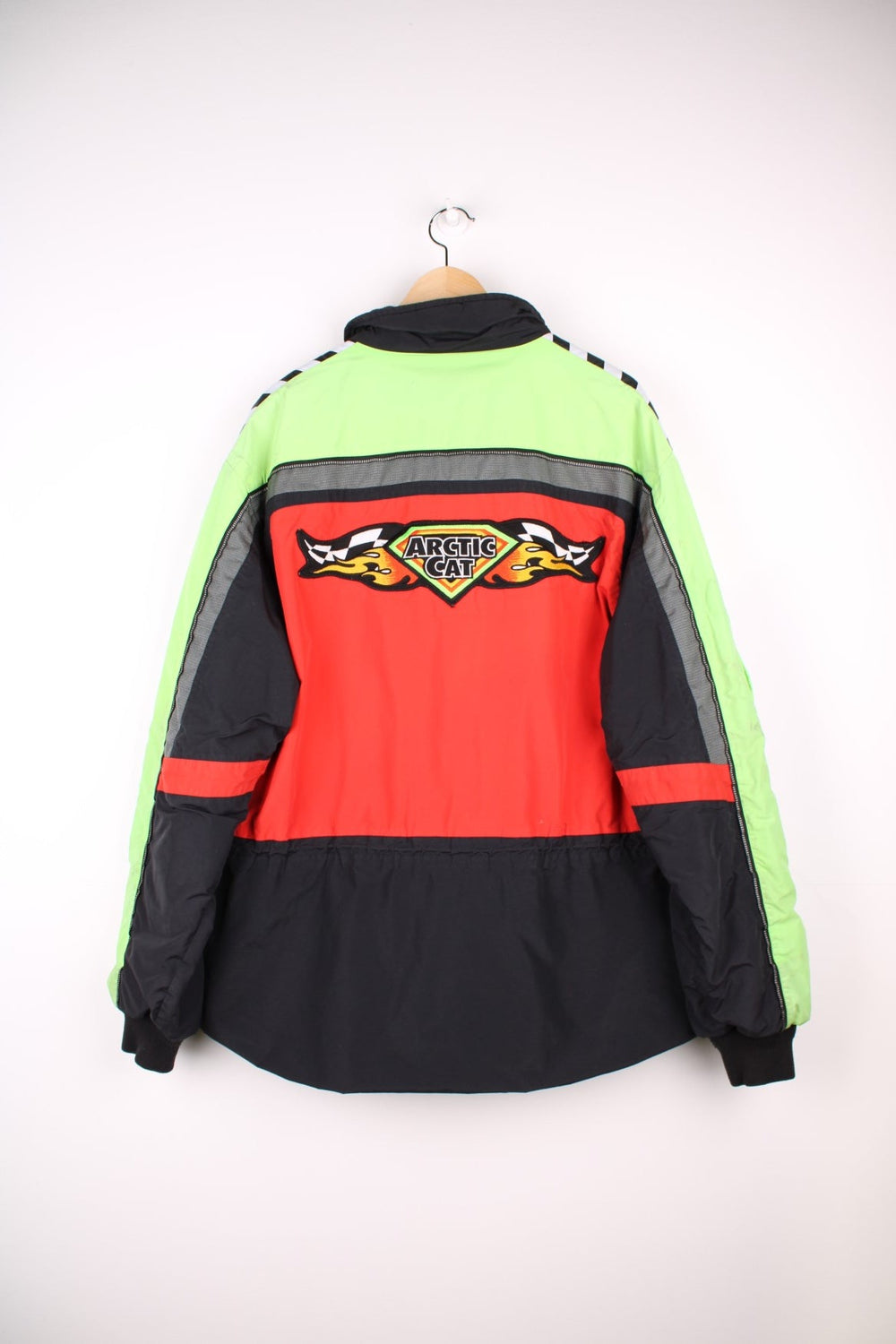  Vintage Arctic Cat racing jacket in a neon green and red colourway. The jacket is from the Arctic Cat, a snowmobile manufacture who also have teams in the Snowmobile Racing leagues. The jacket is gore-tex, has a fleece collar and multiple embroidered patches on the sleeves, front and back.  