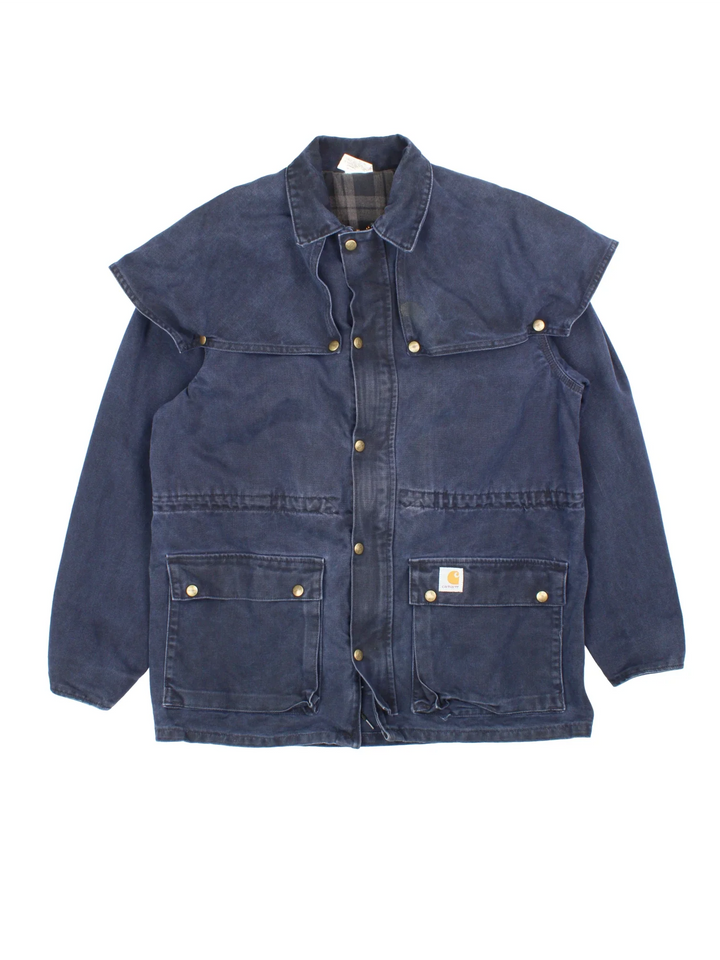 Vintage Carhartt Work Jacket in a navy blue colourway. Zips and buttons up, has side pockets, cape style feature, and has the logo embroidered on the front.