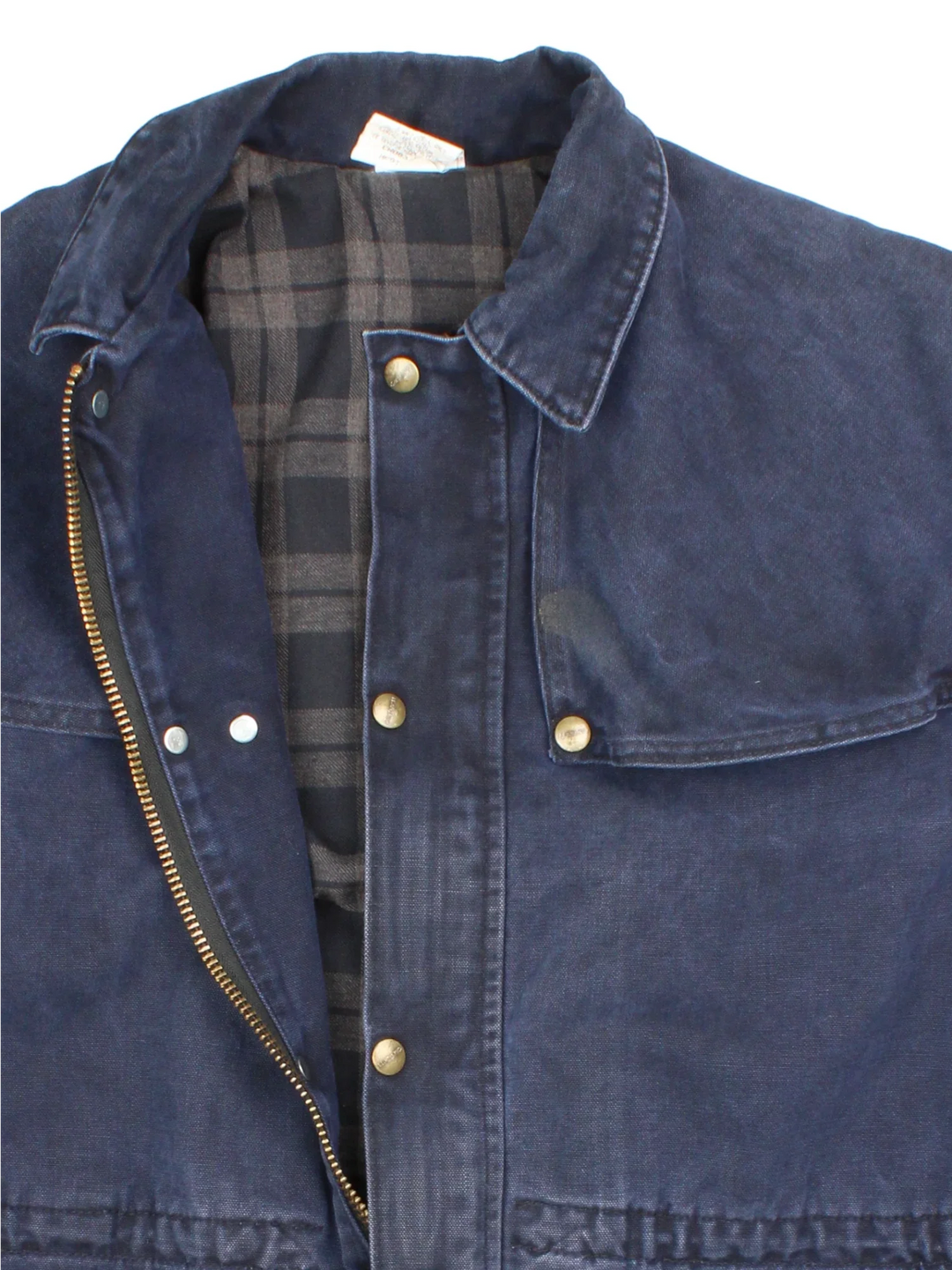 Vintage Carhartt Work Jacket in a navy blue colourway. Zips and buttons up, has side pockets, cape style feature, and has the logo embroidered on the front.