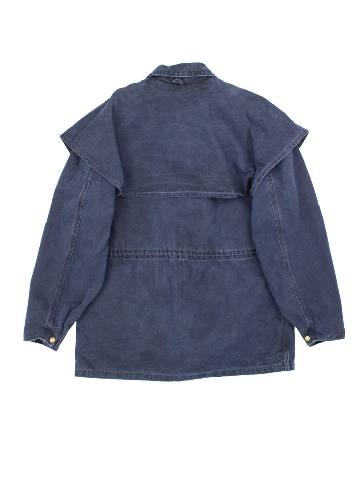 Vintage Carhartt Work Jacket in a navy blue colourway. Zips and buttons up, has side pockets, cape style feature, and has the logo embroidered on the front.