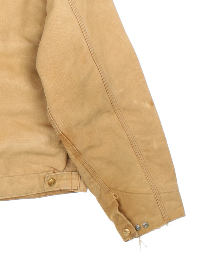 Vintage 80's Carhartt Detroit Jacket in a tan colourway. Zips up and has multiple pockets, insulated with a quilted lining, and has a corduroy collar.