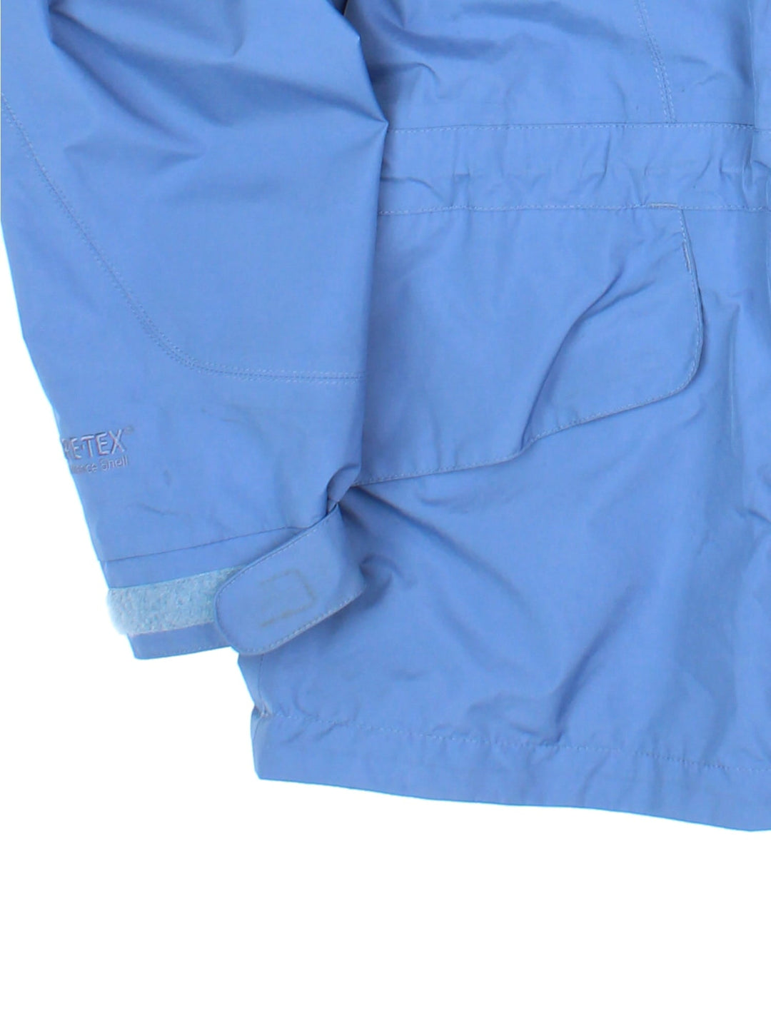 Berghaus Gore-Tex Jacket in a blue colourway. Zips up and has side pockets, mesh lining, hooded, and has the logo embroidered on the front.
