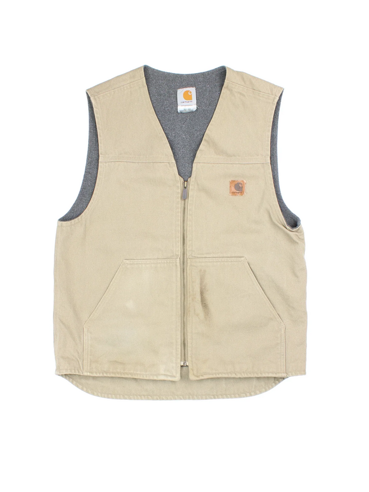 Vintage Carhartt Gilet in a tan colourway. Zips up and has side pockets, fleece lining, and has the logo embroidered on the front.
