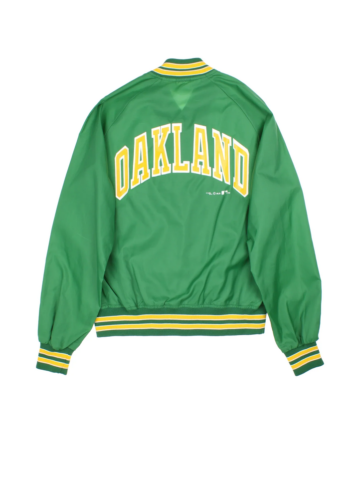 Vintage 1989 Oakland Athletics Chalk Line MLB Varsity Jacket in a green colourway. Zips up and has side pockets, and the team logo / spell out printed on the front and back.