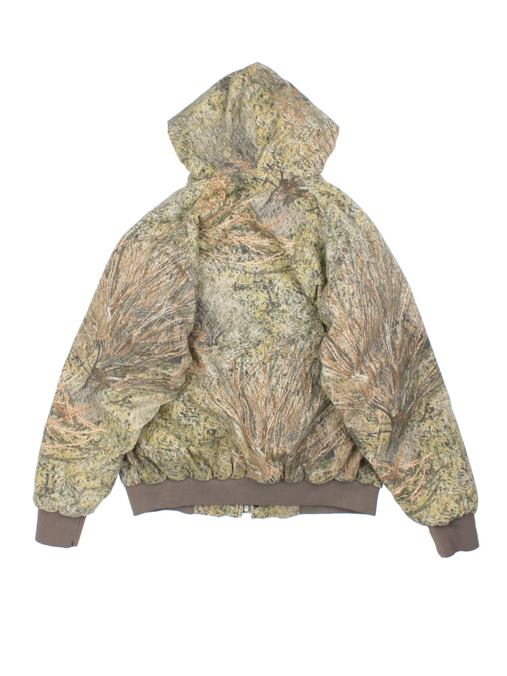 Vintage Russell Athletic Outdoors Mossy Oak Hooded Jacket in a green and green colourway. Zips up and has multiple pockets, insulated with a quilted lining, and has the logo embroidered on the front.