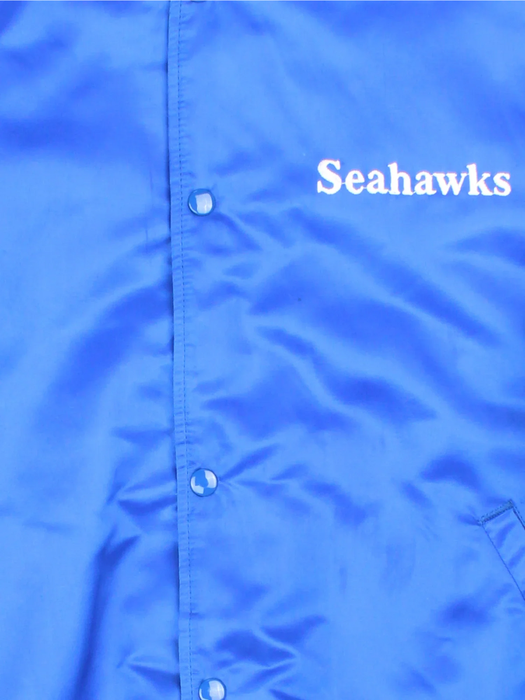 90's Seattle Seahawks NFL Starter Varsity Jacket in a blue colourway. Buttons up and has side pockets, insultaed with a quilted lining, has the team detailing on the sleeves and small logo on the front.