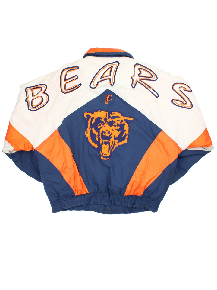 90's Chicago Bears Pro Player Jacket in a white and blue colourway with orange detailing. Full zip up and two pockets on the front with large team logo on the front and sleeves with larger logo and graphic across the back.