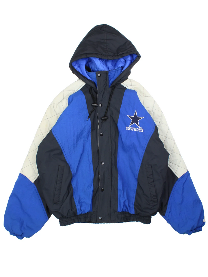 Dallas Cowboys NFL Starter Jacket in a blue and black colourway with grey panelling on the arms. Full zip up with multiple pockets and drawstring hood. Classic logo on the front and sleeves and large star logo on the back.