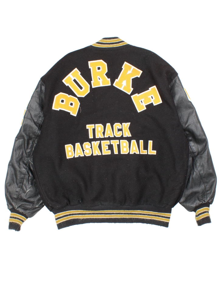 Vintage 'Omaha Burke' College Basketball Varsity Jacket in a black colourway with gold detailing. Classic varsity style with large lettering on the front and spell out on the back, buttons up with side pockets and leather sleeves.