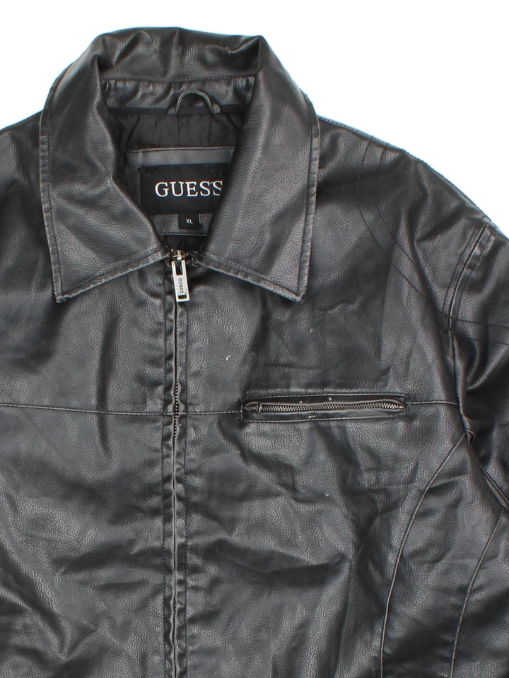 Guess Leather Jacket in a black colourway. Zip fastening with multiple zip pockets, fully lined.