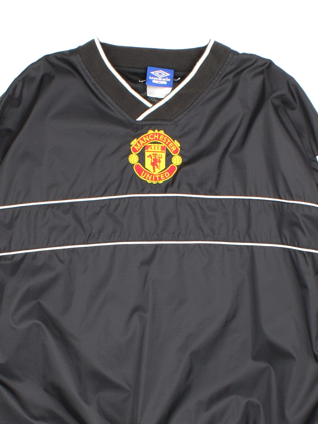 Vintage 90's Manchester United Umbro Drill Training Top in a black colourway. V neck collar and has side pockets, mesh lining, and has the logos embroidered on the front and back.