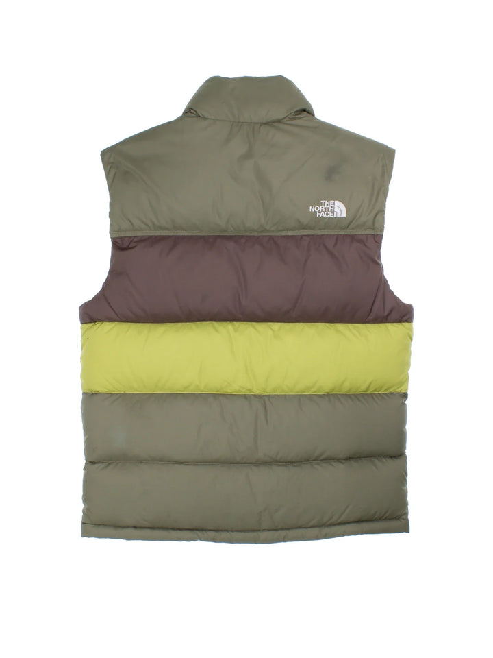 The North Face 700 Gilet in a green colourway with tonal stripe panelling, two pockets, full zip and small classic logo on the front.