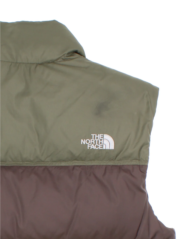 The North Face 700 Gilet in a green colourway with tonal stripe panelling, two pockets, full zip and small classic logo on the front.