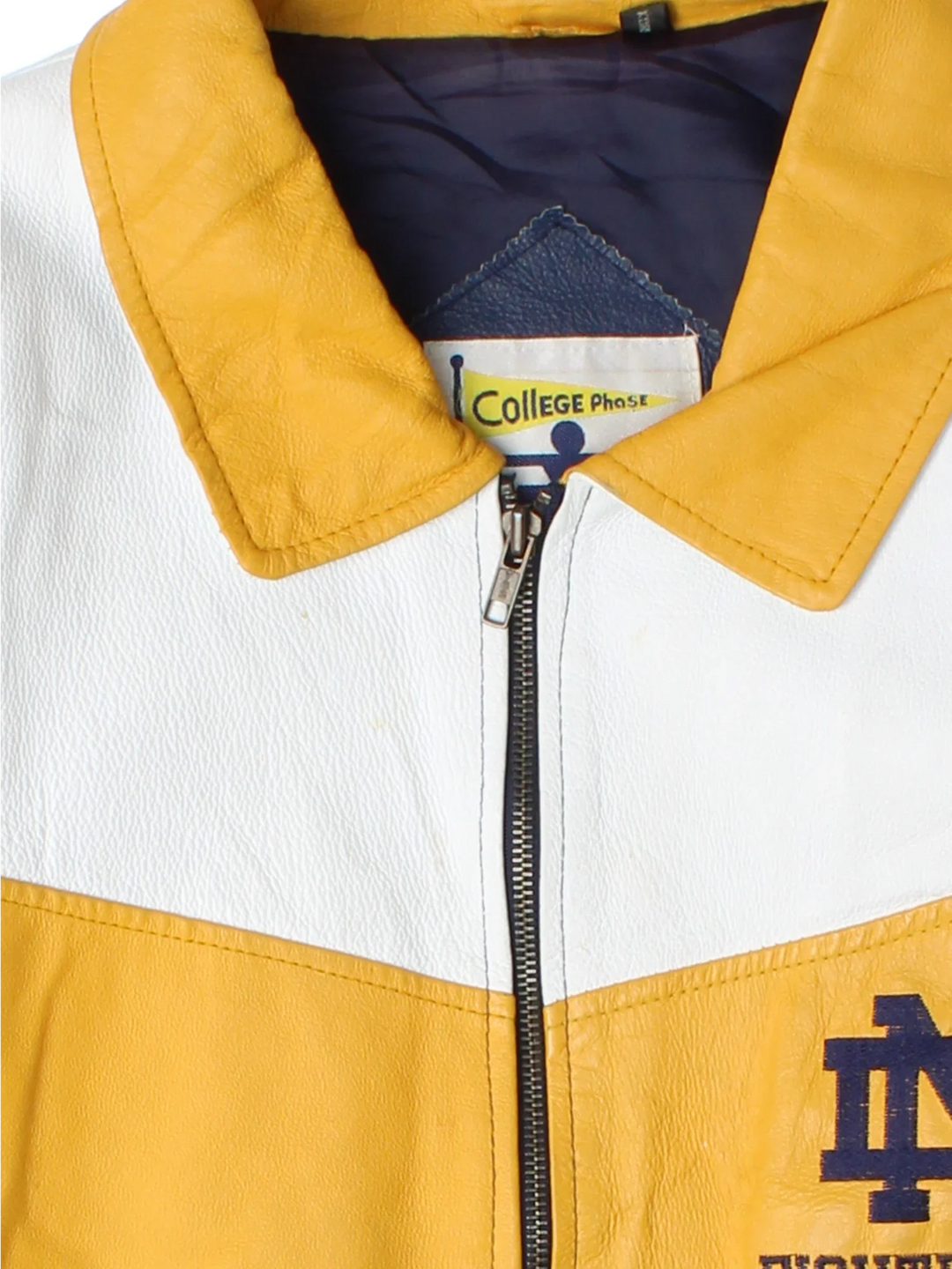 Vintage Notre Dame Fighting Irish VArsity Jacket in a blue colourway with white and yellow panelling. Full zip up and has side pockets, insulated lining, and has the logos embroidered on the front with large graphic on the back.