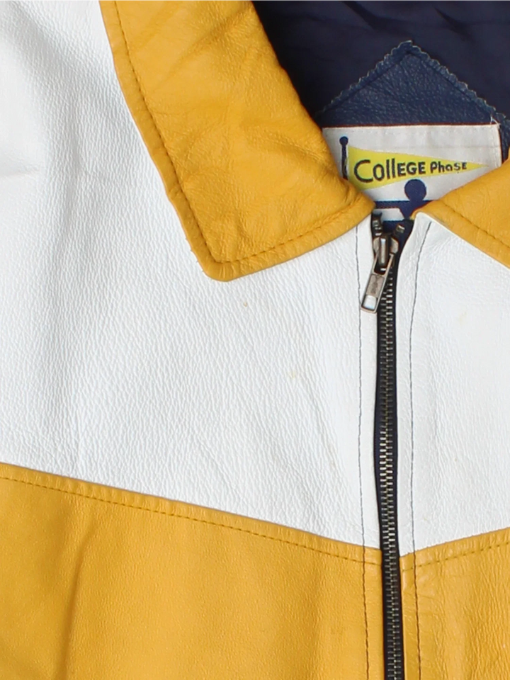 Vintage Notre Dame Fighting Irish VArsity Jacket in a blue colourway with white and yellow panelling. Full zip up and has side pockets, insulated lining, and has the logos embroidered on the front with large graphic on the back.