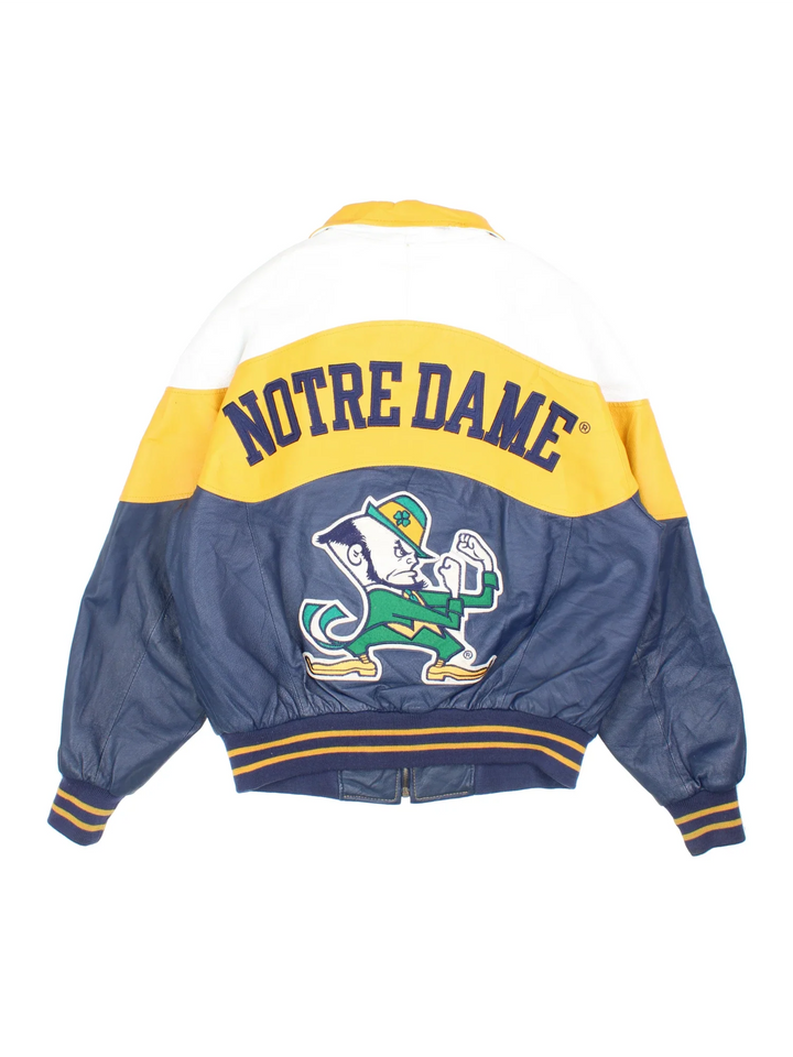 Vintage Notre Dame Fighting Irish VArsity Jacket in a blue colourway with white and yellow panelling. Full zip up and has side pockets, insulated lining, and has the logos embroidered on the front with large graphic on the back.
