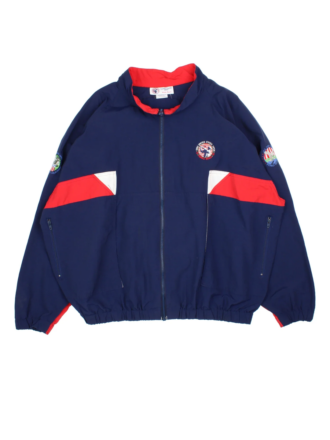 Vintage 1992 US Open Pebble Beach Jacket in a blue colourway with red and white panelling. Full zip with two pockets and small logos on the front and sleeve. Logo and detailing running across the back. 