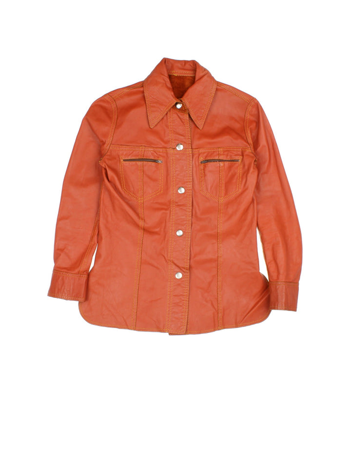 Vintage 80's Reversible Leather Jacket in a orange colourway in either a leather or suede reversible options. Buttons up and has double chest pockets, and features contrast stitching details.