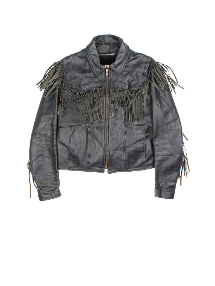 Vintage Schott Leather Fringe Jacket in a black colourway. Zips up and has side pockets, insulated with a detachable sherpa lining, and has fringe tassel details on the front, back and down the sleeves.