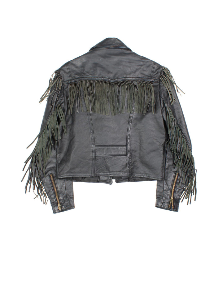 Vintage Schott Leather Fringe Jacket in a black colourway. Zips up and has side pockets, insulated with a detachable sherpa lining, and has fringe tassel details on the front, back and down the sleeves.