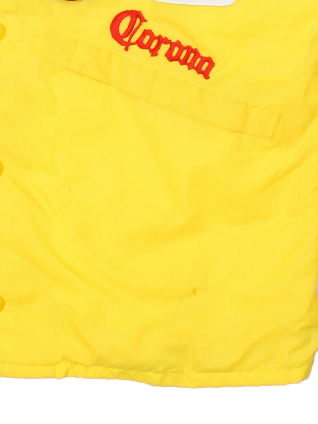 70's Vintage Coach Jacket in a yellow/multi colourway. Button popper fastening with front pockets, elasticated cuffs and hem with brushed lining. Embroidered patches and logos on front and back.